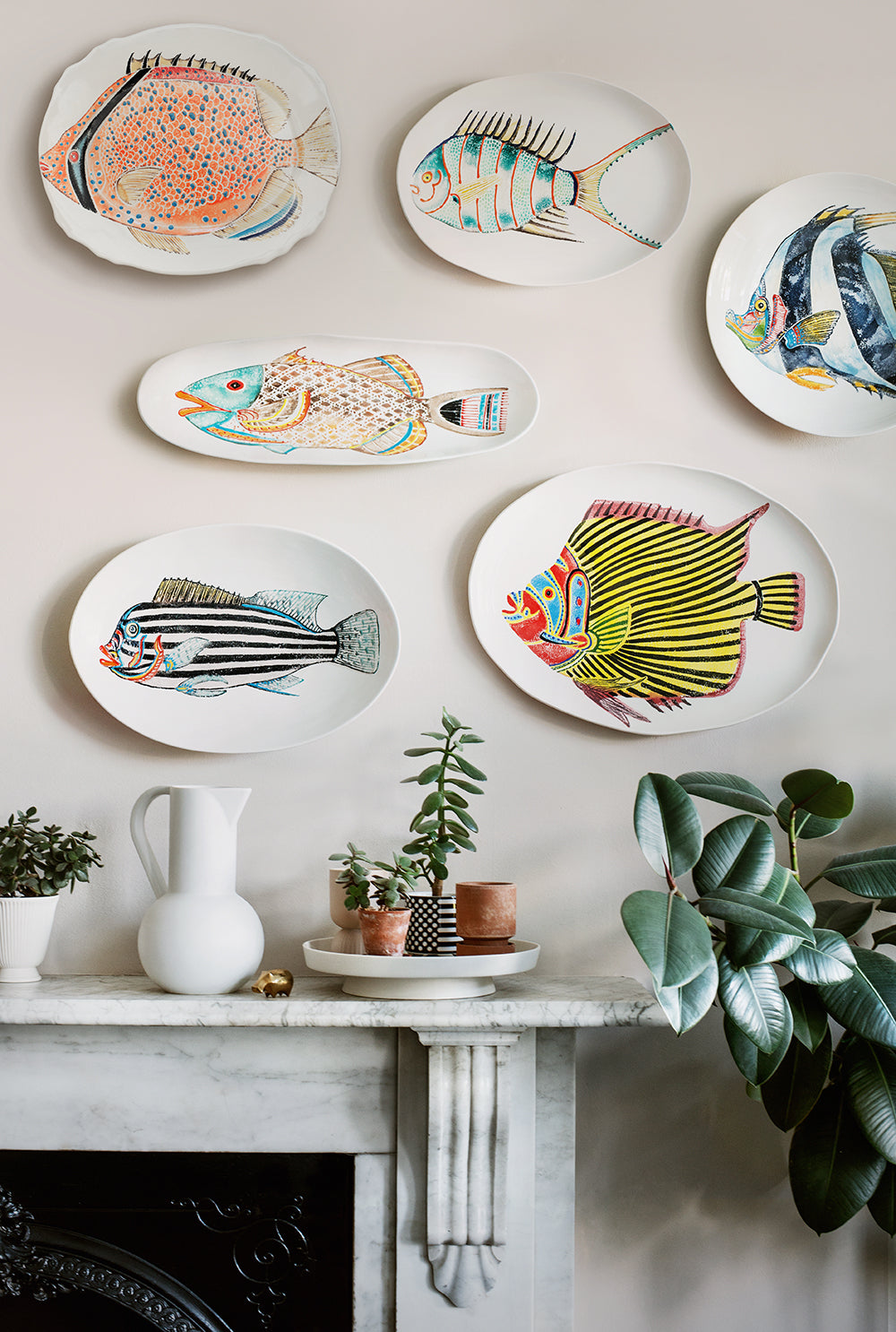 Collections of Fantastical Fish platters hung on a wall